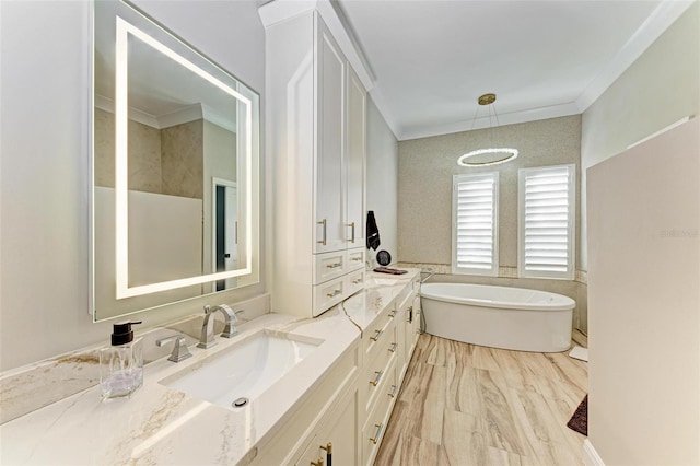 bathroom featuring vanity, ornamental molding, and a bath