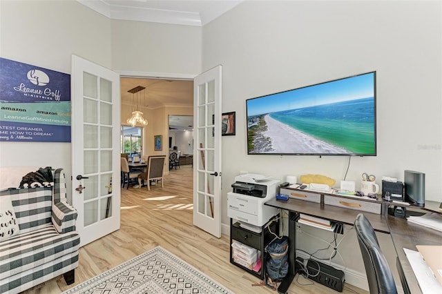 office with crown molding, french doors, and light hardwood / wood-style floors