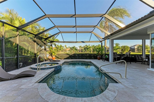 view of pool with an in ground hot tub, glass enclosure, and a patio area