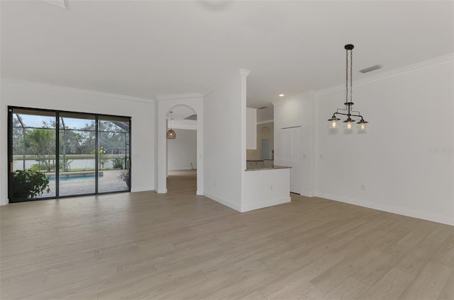 unfurnished living room with crown molding and light hardwood / wood-style floors