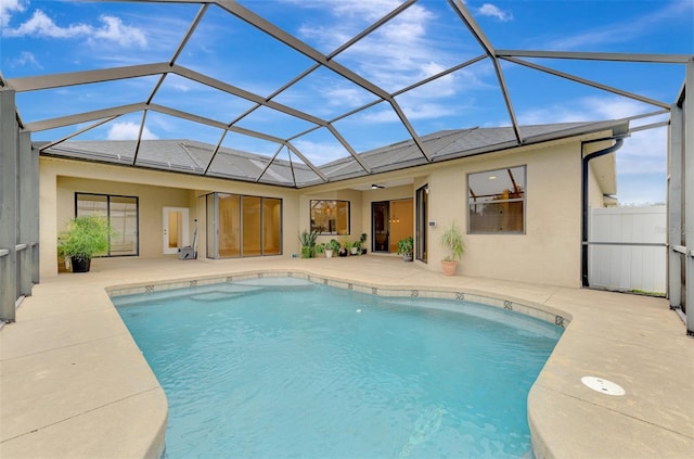 view of swimming pool featuring a patio and a lanai