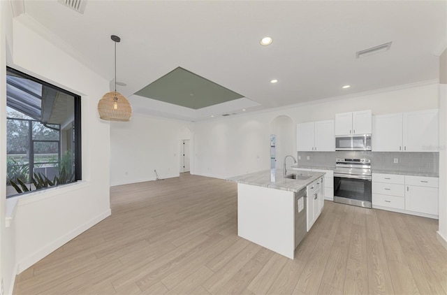 kitchen featuring pendant lighting, sink, white cabinetry, stainless steel appliances, and light stone countertops