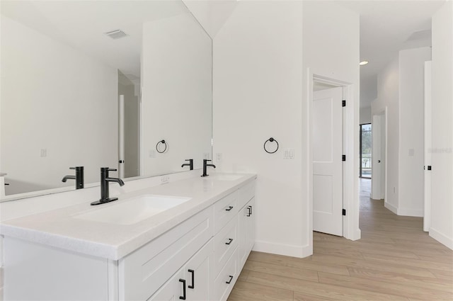 bathroom with vanity and hardwood / wood-style floors