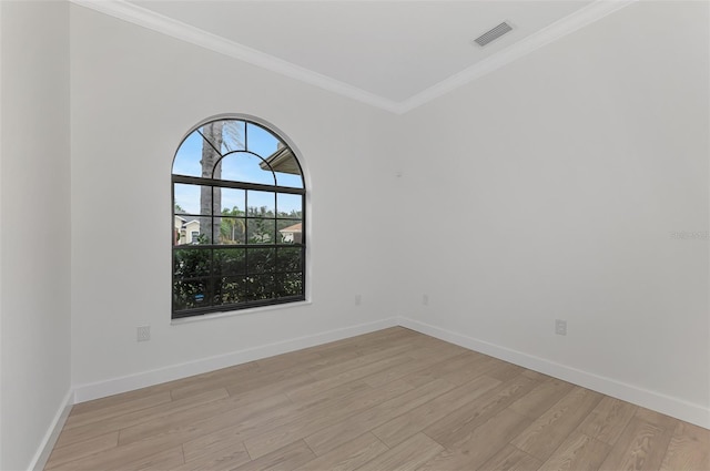 unfurnished room featuring ornamental molding and light hardwood / wood-style floors