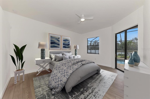 bedroom featuring hardwood / wood-style floors, access to outside, and ceiling fan