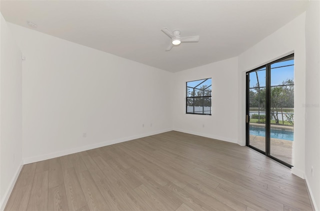 empty room with ceiling fan and light wood-type flooring