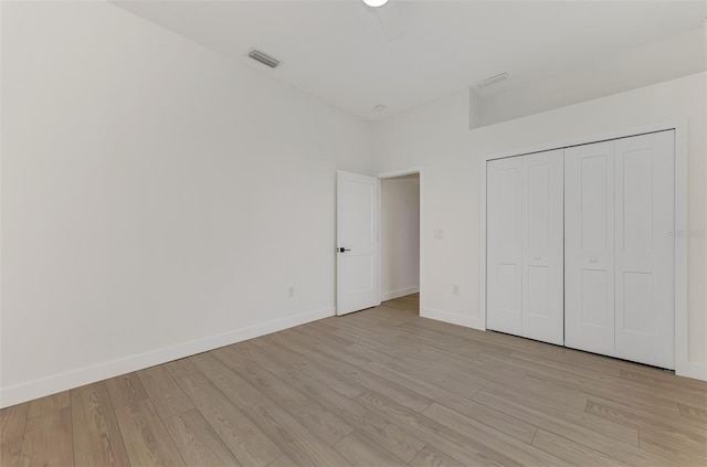 unfurnished bedroom featuring a closet and light hardwood / wood-style flooring