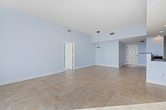 tiled empty room featuring sink