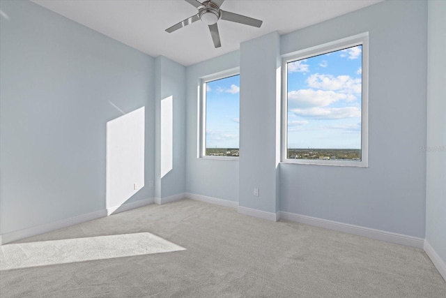 carpeted empty room with ceiling fan