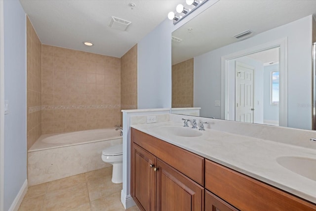 full bathroom featuring toilet, vanity, tiled shower / bath combo, and tile patterned flooring