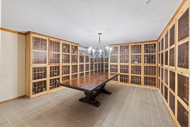 wine area with tile patterned floors and an inviting chandelier