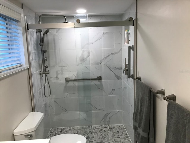 full bathroom with a stall shower and toilet