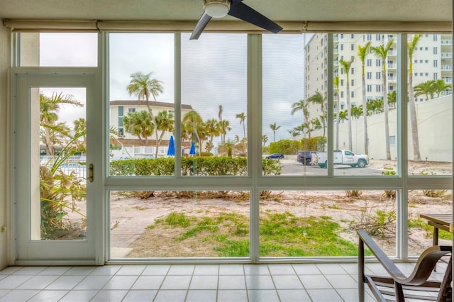 unfurnished sunroom featuring ceiling fan