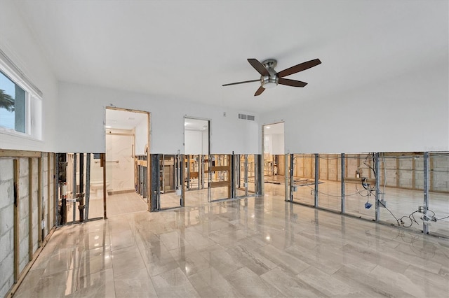 empty room with visible vents and ceiling fan