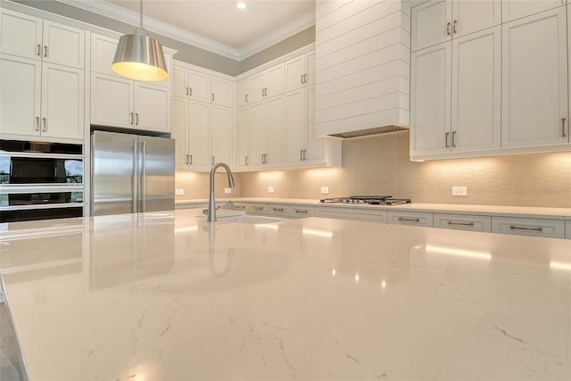 10612 Nicklaus Ct, Englewood, FL 34223 - kitchen featuring stainless steel appliances, crown molding, a sink, backsplash, and wall chimney exhaust hood
