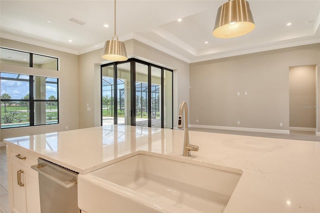 10612 Nicklaus Ct, Englewood, FL 34223 - kitchen with a sink, dishwasher, hanging light fixtures, light stone countertops, and white cabinets