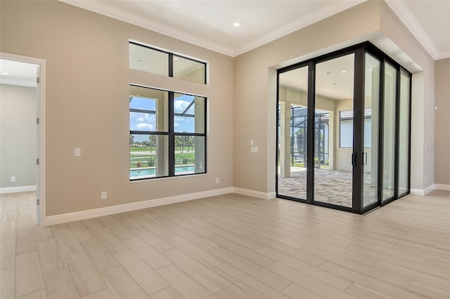 10612 Nicklaus Ct, Englewood, FL 34223 - empty room featuring crown molding, baseboards, light wood finished floors, and recessed lighting