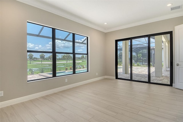 10612 Nicklaus Ct, Englewood, FL 34223 - empty room with healthy amount of natural light, crown molding, baseboards, light wood finished floors, and recessed lighting