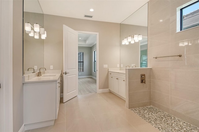 10612 Nicklaus Ct, Englewood, FL 34223 - full bath featuring two vanities, plenty of natural light, tile patterned flooring, recessed lighting, and baseboards