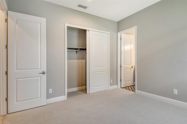 10612 Nicklaus Ct, Englewood, FL 34223 - unfurnished bedroom with carpet floors, a closet, and baseboards