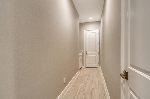 10612 Nicklaus Ct, Englewood, FL 34223 - hall featuring baseboards, light wood-style flooring, and recessed lighting