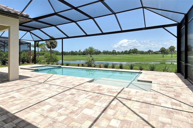 10612 Nicklaus Ct, Englewood, FL 34223 - view of swimming pool featuring a patio area, a pool with connected hot tub, a lanai, and a water view