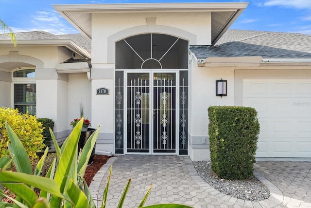 doorway to property with a garage