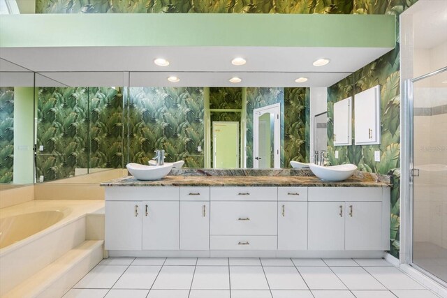 bathroom with tile patterned floors, plus walk in shower, and vanity