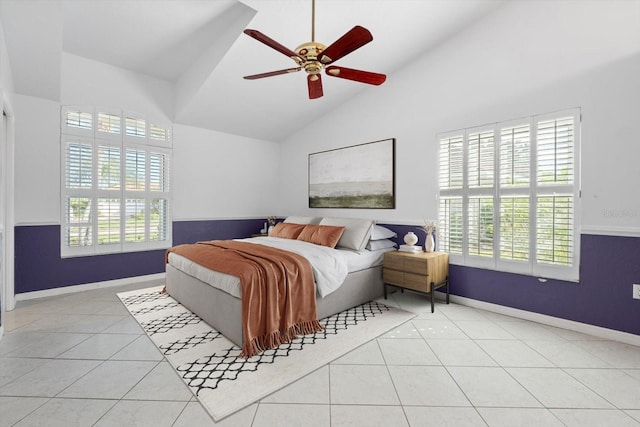 bedroom with ceiling fan, light tile patterned flooring, and vaulted ceiling