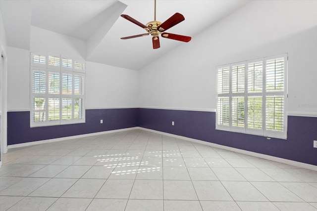 tiled empty room featuring ceiling fan and high vaulted ceiling