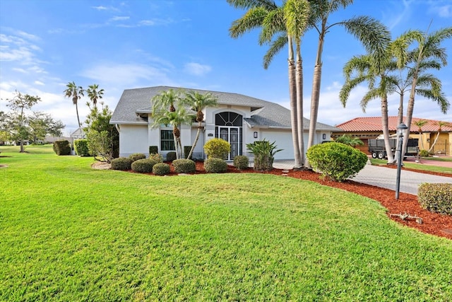 view of front facade featuring a garage and a front lawn