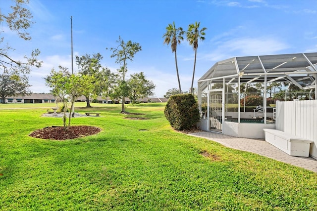 view of yard featuring glass enclosure