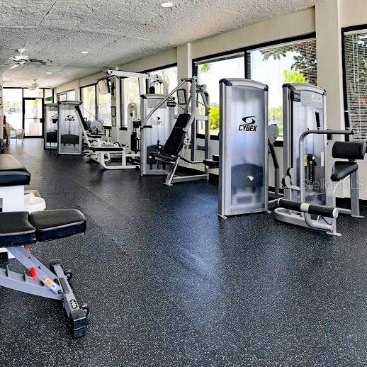 exercise room featuring ceiling fan and a textured ceiling