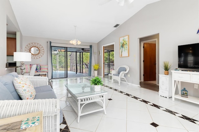 tiled living room with ceiling fan with notable chandelier and vaulted ceiling