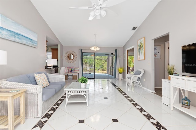 living room featuring ceiling fan with notable chandelier, lofted ceiling, and light tile patterned flooring