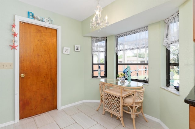 dining area with light tile patterned floors and a notable chandelier