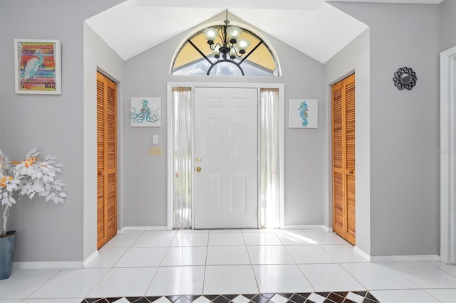 tiled entrance foyer with an inviting chandelier and lofted ceiling