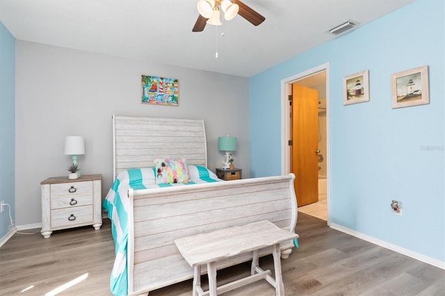 bedroom with dark hardwood / wood-style flooring and ceiling fan