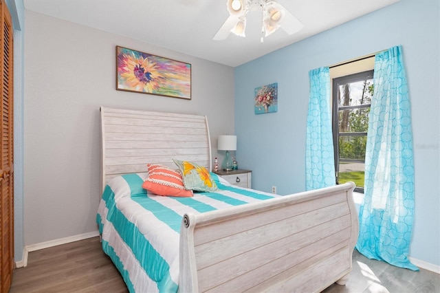 bedroom featuring ceiling fan, dark wood-type flooring, and a closet