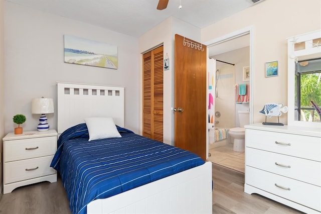 bedroom featuring light hardwood / wood-style floors, ensuite bath, a closet, and ceiling fan