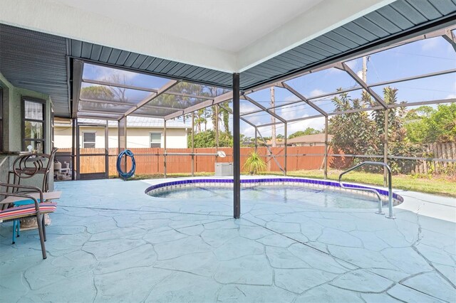 view of swimming pool with a lanai and a patio