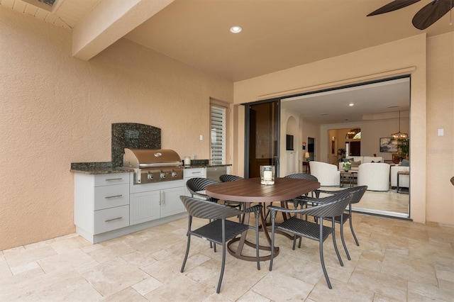 view of patio featuring area for grilling and ceiling fan