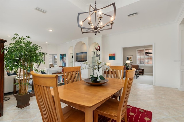 dining space featuring light tile patterned floors, a chandelier, and ornamental molding