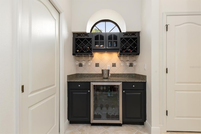 bar with light tile patterned flooring and beverage cooler