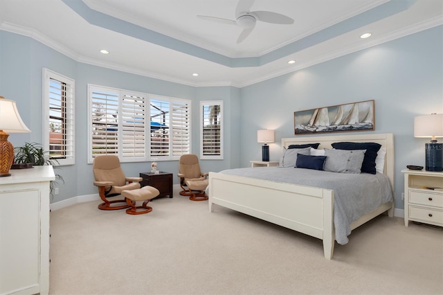 bedroom featuring a raised ceiling, ceiling fan, light carpet, and ornamental molding