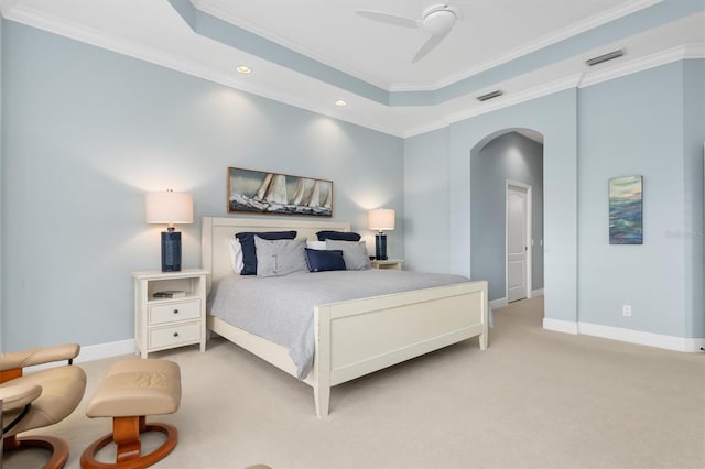 bedroom featuring a tray ceiling, ceiling fan, light colored carpet, and ornamental molding