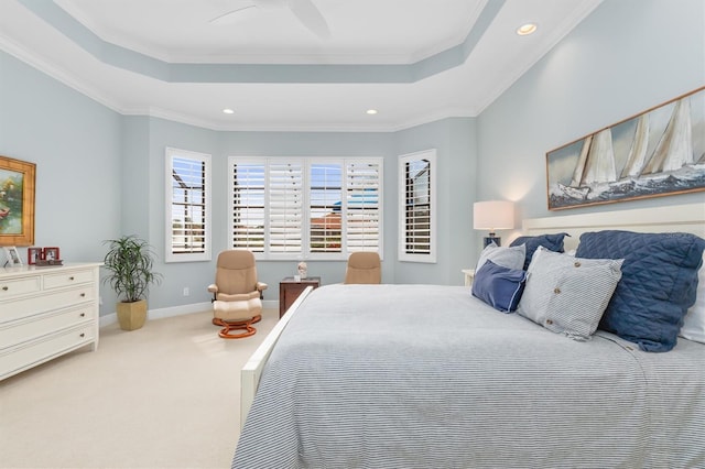 carpeted bedroom featuring a raised ceiling, ceiling fan, and crown molding