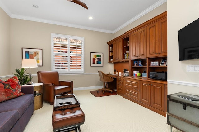 carpeted office space with built in desk and crown molding