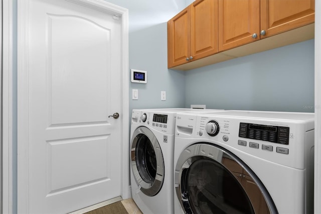 laundry room with cabinets and separate washer and dryer