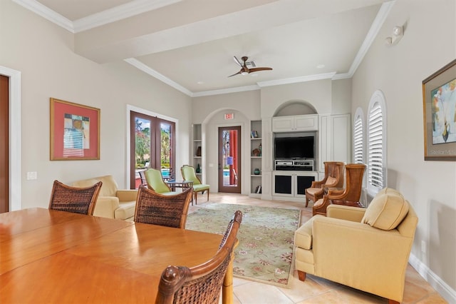 dining space with built in shelves, ceiling fan, light tile patterned floors, and crown molding